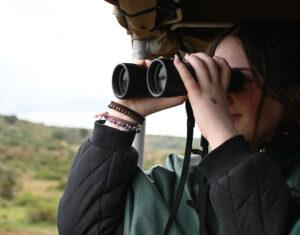 A guest photographing wildlife on a game drive in Zuurberg Mountain Village, South Africa.