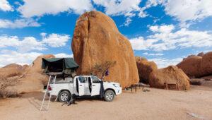A rooftop tent set up at a campsite on a guided self-drive tour in Namibia.