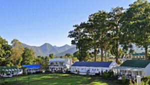 Views of Tsitsikamma Village Inn with mountains and trees in the background.