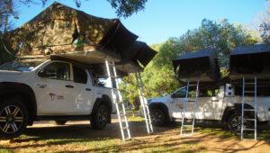 A rooftop tent set up on a 4x4 vehicle at the Atlantis Dunes on a guided self-drive.