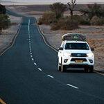 Vehicle on a long straight road, on a guided self drive cape town to namibia.