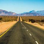 A long straight tarmac road leading to the horizon on Route 62.