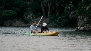 A father and son canoeing on the river at Lambazi Lodge.