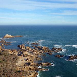 Aerial view of rocky coastline and rugged shoreline along the Garden Route, South Africa.