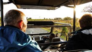 Guests on an open game drive vehicle at sunset in iSimangaliso Wetland Park
