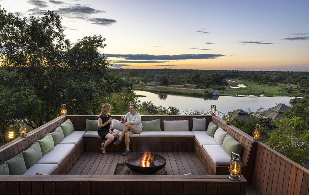 A honeymoon couple on the sundowner viewing deck at Simbavati Hilltop Lodge in South Africa.