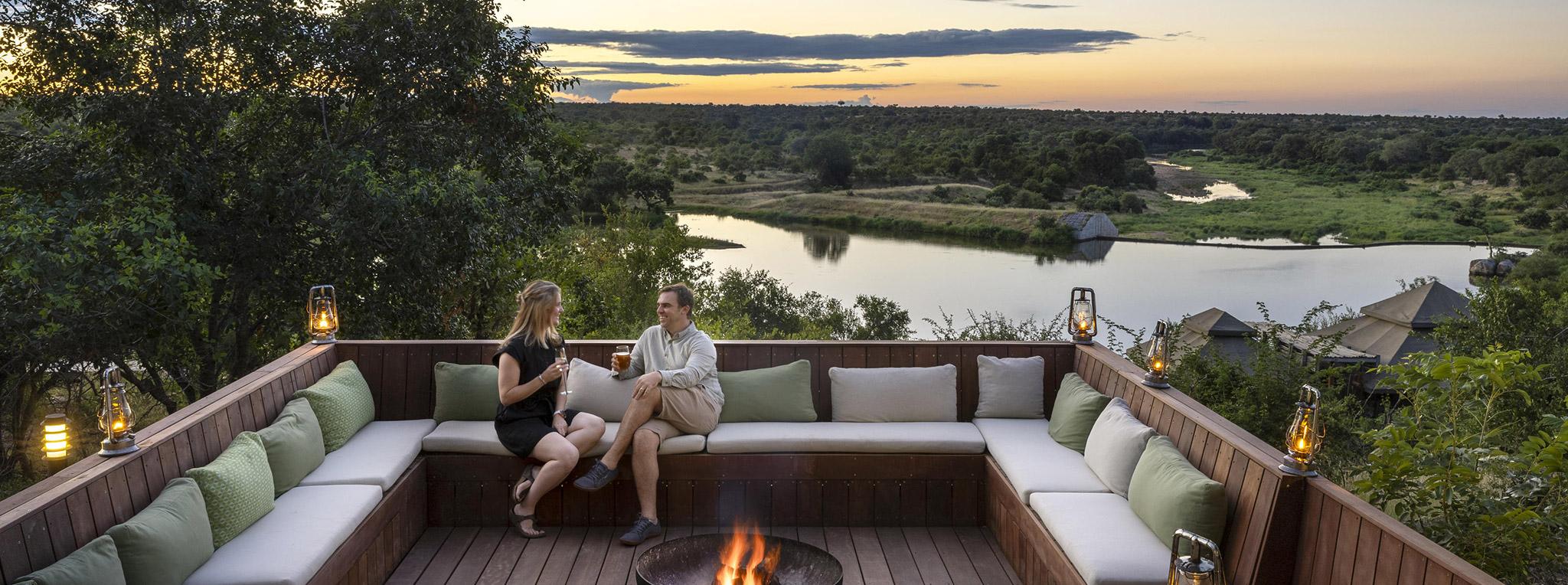 A honeymoon couple on the sundowner viewing deck at Simbavati Hilltop Lodge in South Africa.