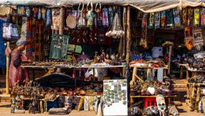 Colourful roadside craft market stall with local artworks, carvings and textiles along the Panorama Route, South Africa.