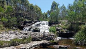 A waterfall cascading over rocks in the forest near Mbotyi River Lodge at the Wild Coast in South Africa.