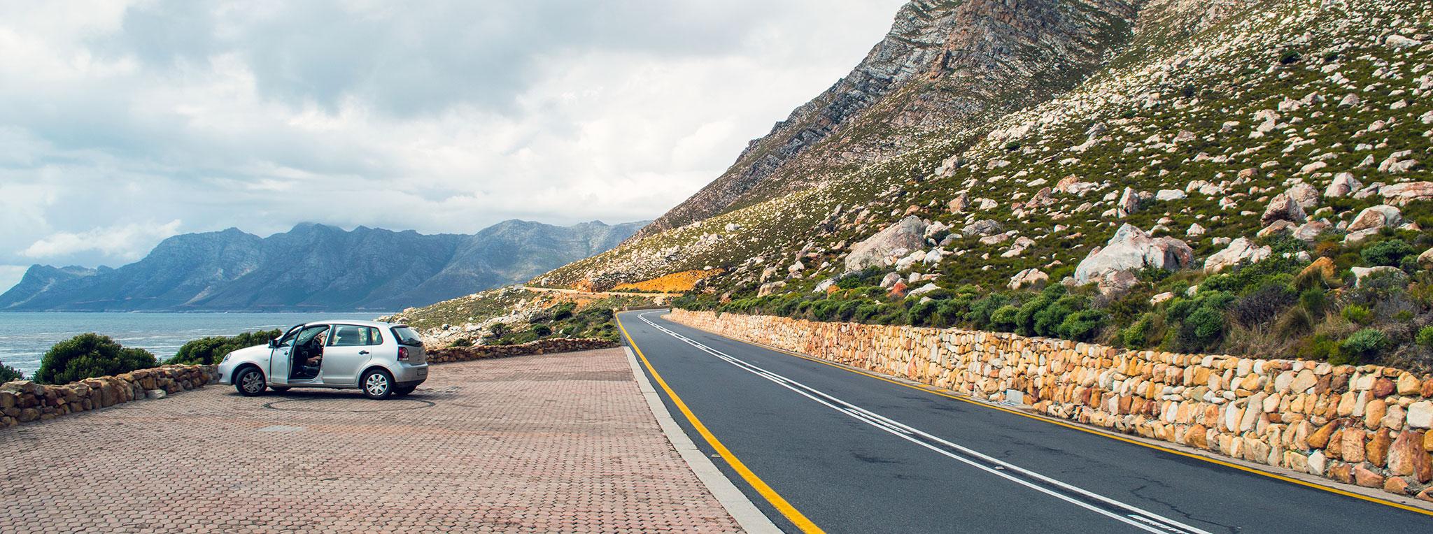Coastal road with a mountain range near Cape Town on a South Africa self-drive tour.