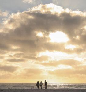 A private group of travellers in South Africa at the beach at sunset.