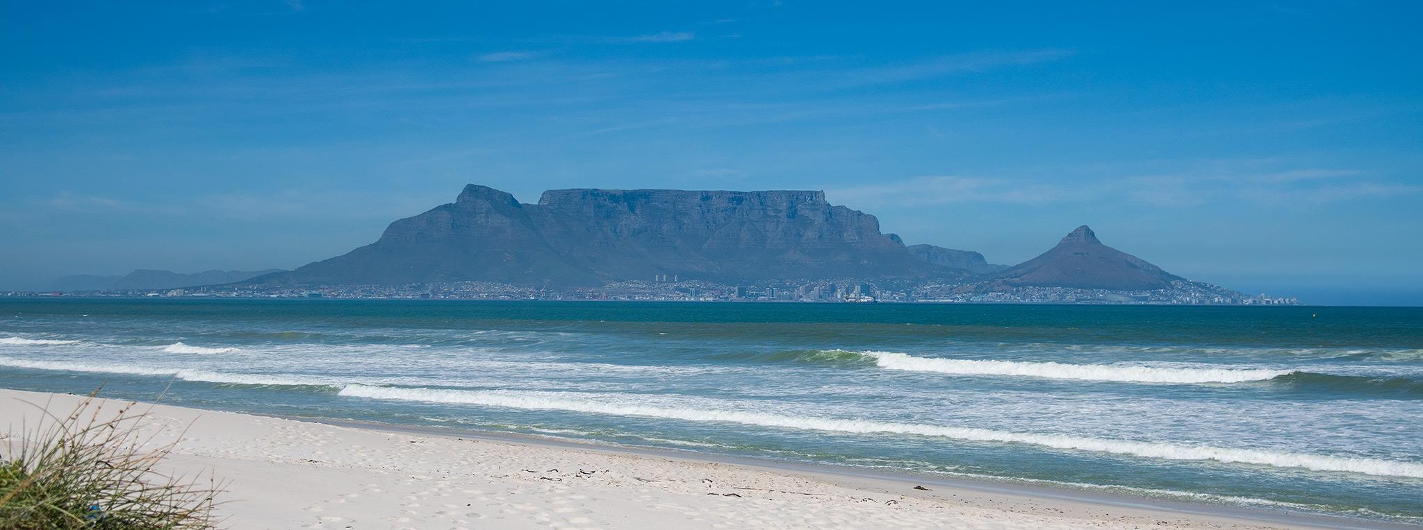 Views of Table Mountain and Lions Head from across the bay at Blouberg Beach.
