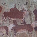 Ancient rock art at Drakensberg, South Africa, depicting people and animals, relevant to Drakensberg and Kruger tour.