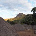 Mountains and traditional village huts, South African tour in Swaziland.