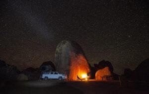 Self-drive safari campsite with campfire and stars in Southern Africa