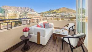 Balcony view from Cape Grace with a table and chairs overlooking Table Mountain and Lion's Head.