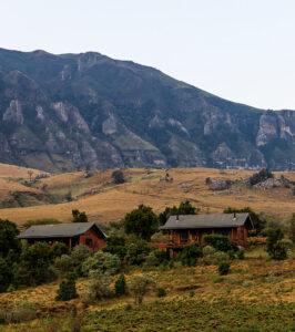 Log cabins at Greenfire Drakensberg at the bottom of the dramatic mountain range.