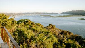 Scenic view of Knysna lagoon and lush green hills, South Africa.