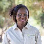 Young woman in South Africa Experience uniform, smiling outdoors