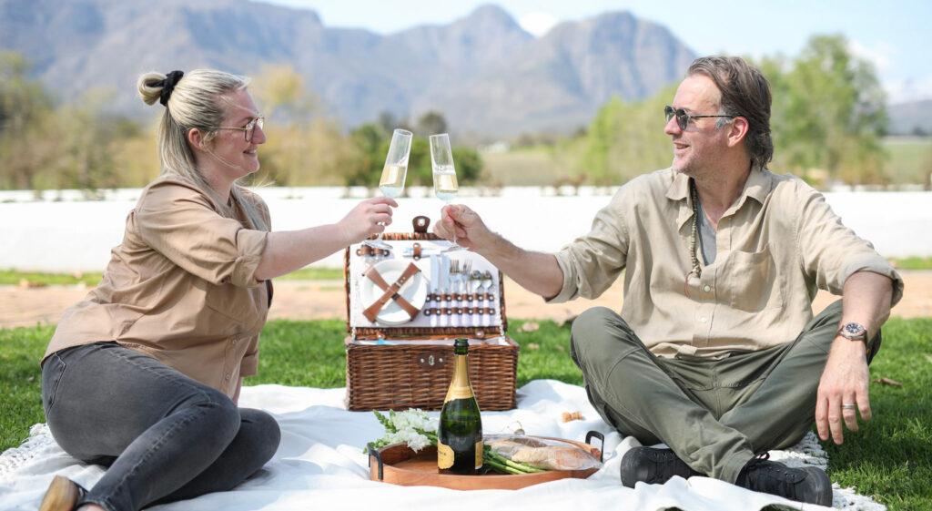 Couple enjoying a wine picnic in the Winelands, South Africa