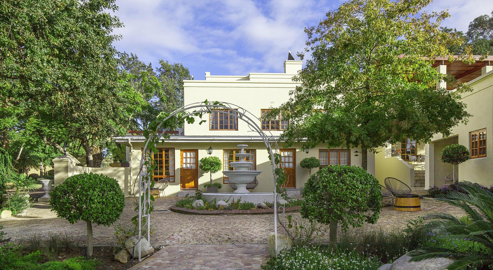 Charming South African guesthouse with fountain and garden, ideal accommodation. Charming South African guesthouse with fountain and garden, ideal accommodation.