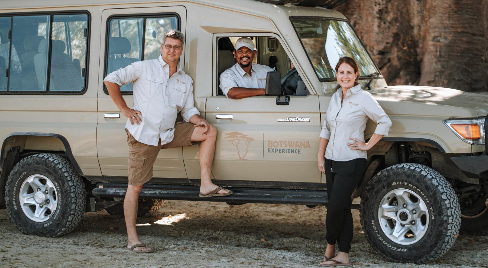 Three people pose by a Land Cruiser, offering South African safari tips. Three people pose by a Land Cruiser, offering South African safari tips.