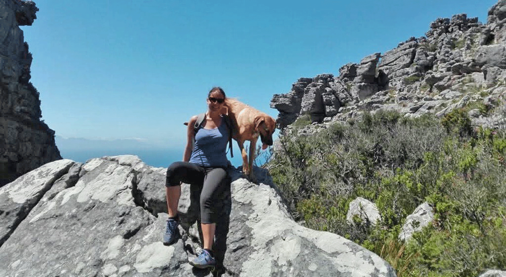 Woman and dog on rocky mountain hike, South Africa self-drive tip Woman and dog on rocky mountain hike, South Africa self-drive tip