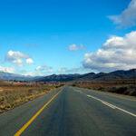 Open road in South Africa, with mountains and blue sky