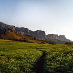 Scenic Drakensberg mountain range with lush green grass
