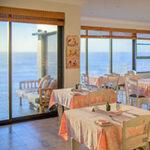 Ocean view dining area with tables set for breakfast