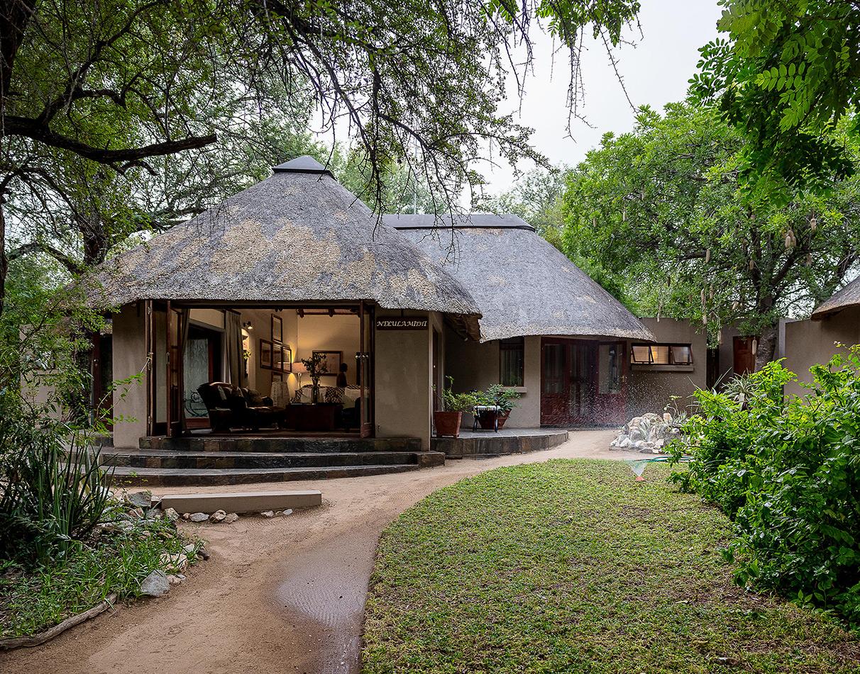 Ivory Wilderness River Rock Lodge in a lush, green environment